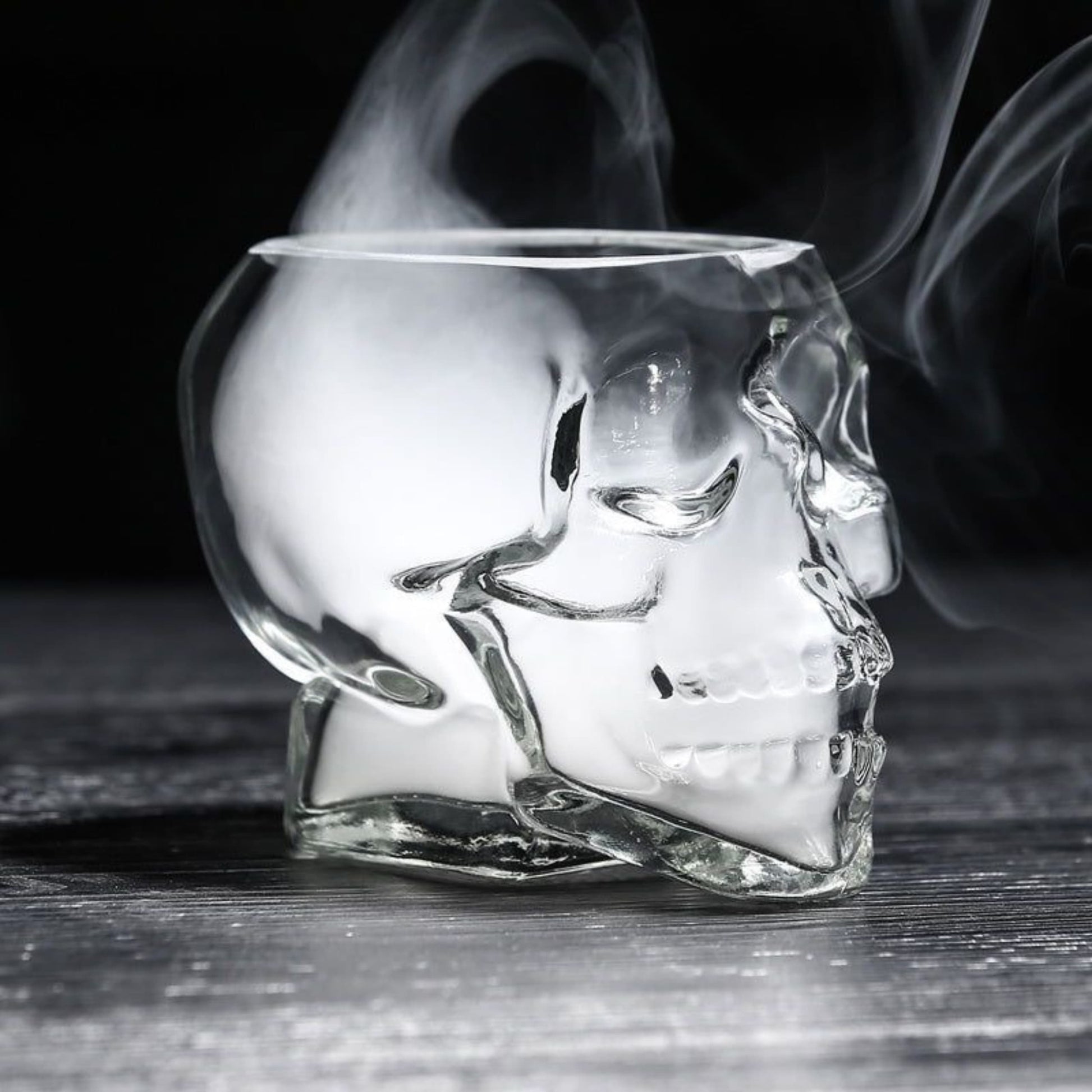 Vaso calavera cristal 3D transparente sosteniendo bebida oscura estilo whisky