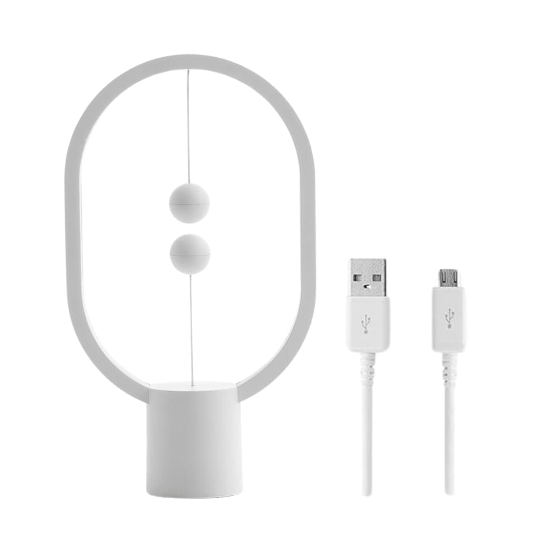 Detalle de esferas magnéticas suspendidas activando lámpara de equilibrio LED