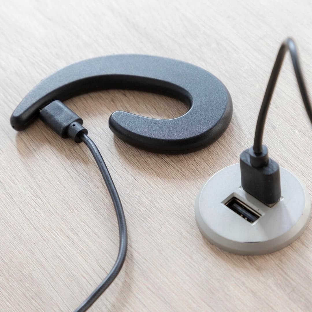 Auricular inalámbrico open-ear conectado a smartphone durante actividad al aire libre
