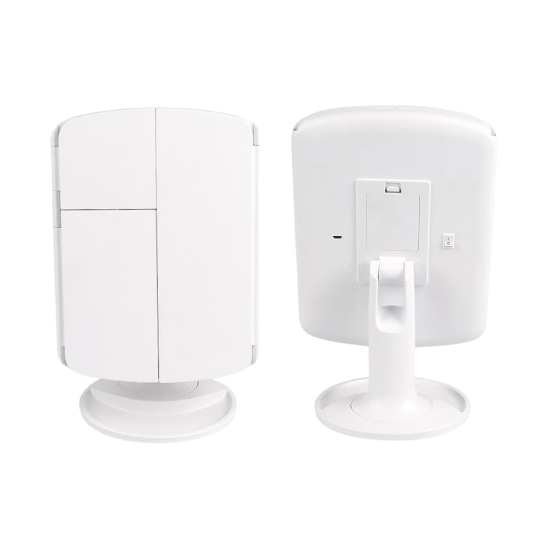 Espejo LED con diseño plegable sobre tocador blanco, ambiente moderno.