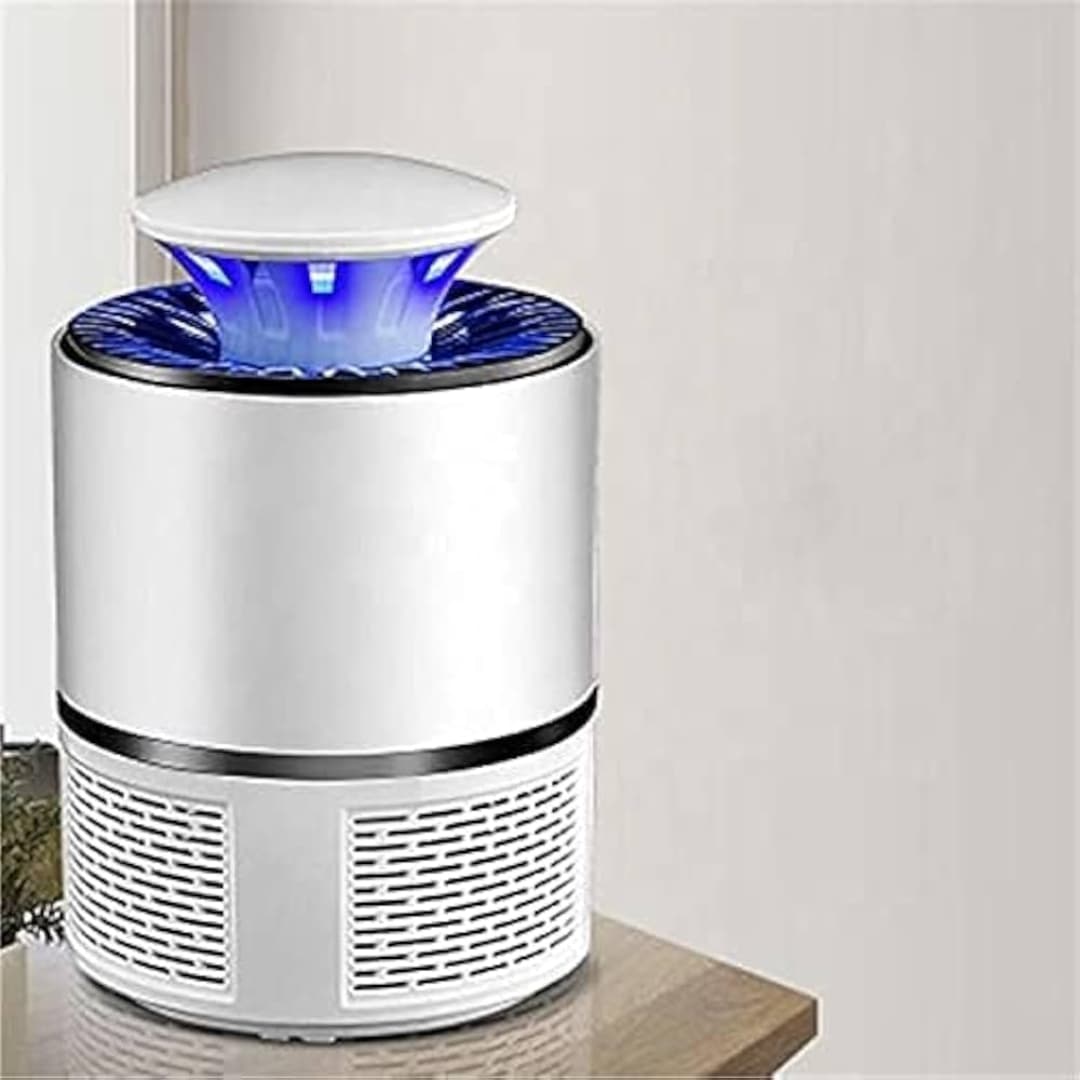 Lámpara antimosquitos blanca en mesa auxiliar, ideal para interiores sin ruido ni químicos.