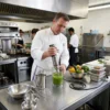 Batidora de mano para cocina profesional Chef profesional utilizando la batidora de inmersión de 1000W para preparar salsas y purés en una cocina industrial.