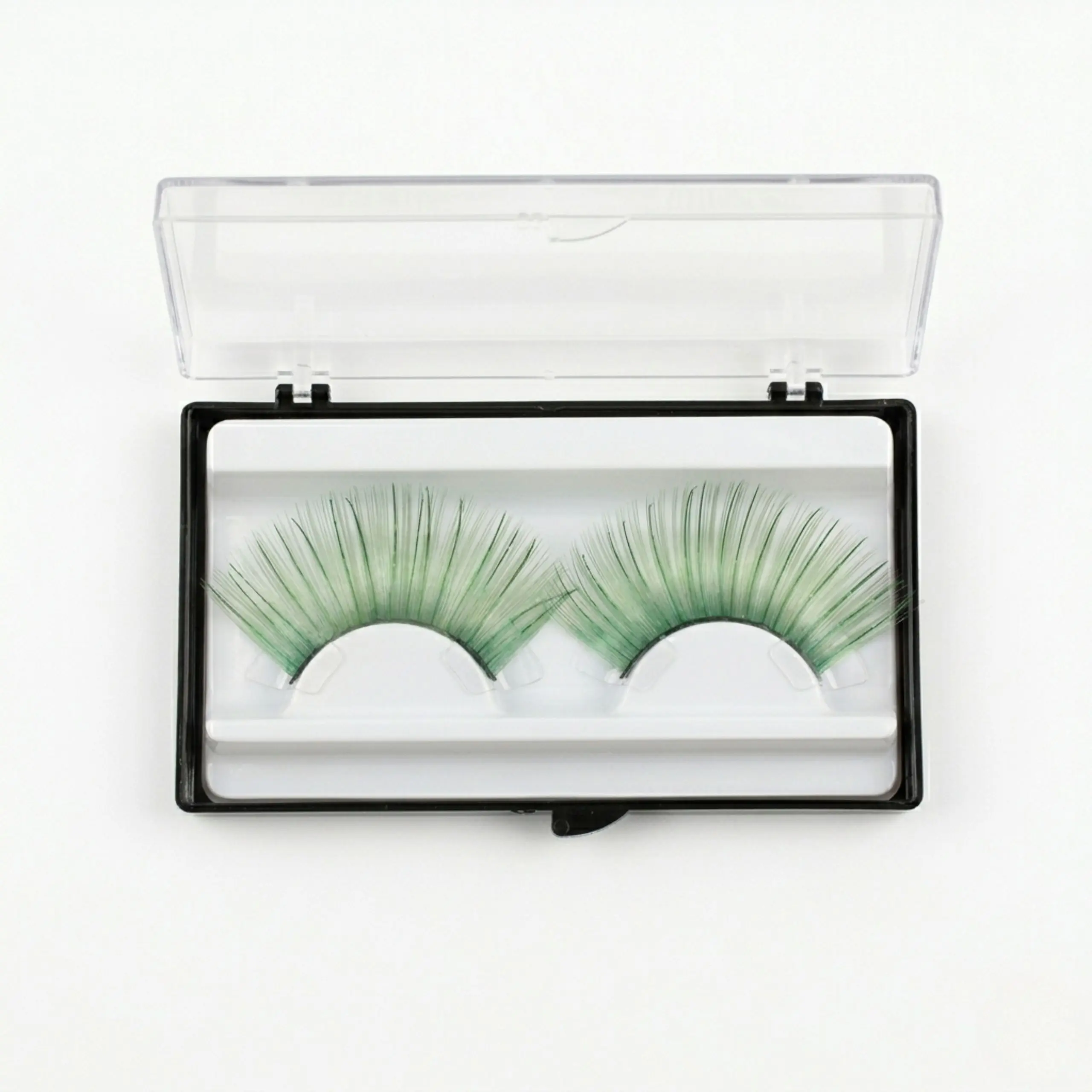 Pestañas Postizas Verdes en Estuche Protector Par de pestañas postizas verde esmeralda reutilizables en su caja de almacenamiento transparente para maquillaje de fantasía.