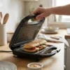 Sándwich Caprese con marcas de parrilla auténticas Detalle de sándwich caliente con vapor y marcas de grill crujientes recién hecho en la prensadora de panini profesional.