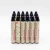 Pack de Barras de Maquillaje de Larga Duración Lote de barras de maquillaje en stick tono negro intenso con diseño de puntos de colores, ideal para uso profesional y personal.